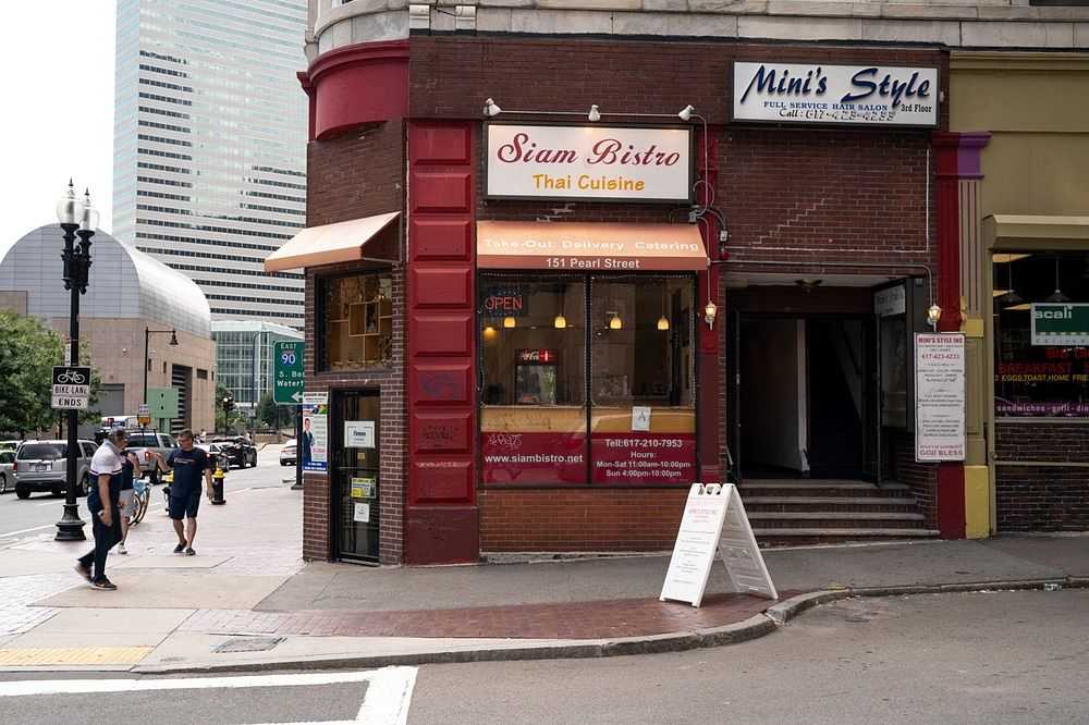 Thai restaurant Siam Bistro with a street view and pedestrian activity.